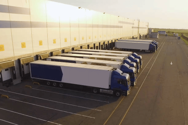 Commercial trucks within a warehouse vicinity